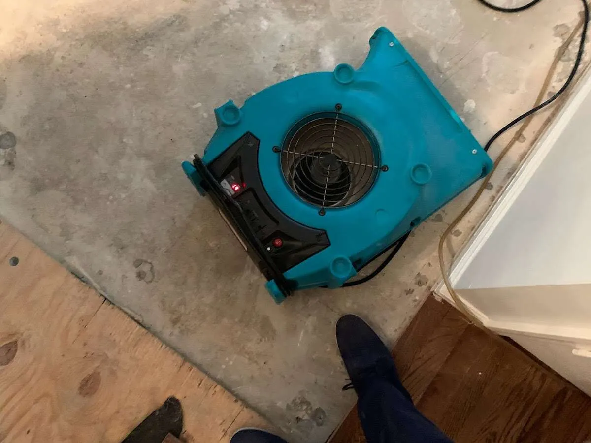 Air mover drying subfloor during Commercial Water Damage Restoration in Barstow
